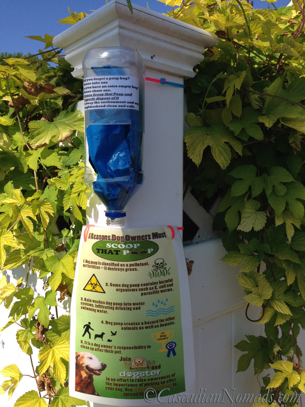 A DIY Community Poop Bag Share Station Zip Tied to a vinyl fence post #ScoopThatPoop